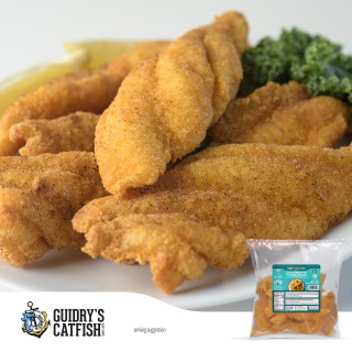 Guidry's Catfish Guidrys Breaded Catfish Strips 2lb, close-up of crispy, golden-brown breaded catfish strips on a white plate with lemon wedges and green broccoli in the background.