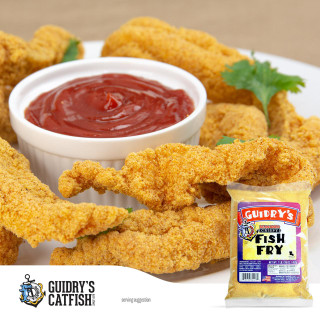 Guidry's Catfish Guidrys Fish Fry Batter 1lb, crispy fried fish fillets with a side of red dipping sauce on a white plate.