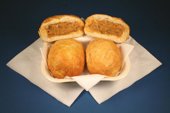 Cajun Original Crab Pistolettes 24 Pack, image of golden fried crab filled pastry puffs on a white basket with a divided filling revealed in the cut-open pastry.