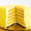 Gambino's Lemon Doberge Cake, cross-section showing multiple layers of lemon-flavored cake and creamy filling covered in a bright yellow lemon glaze