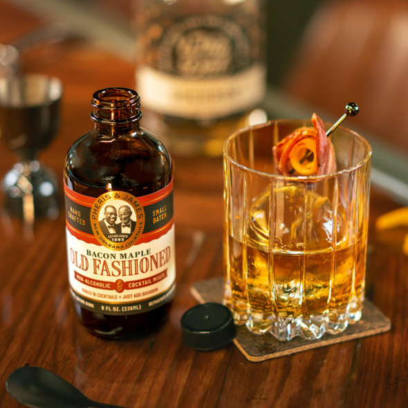 Pheris & James Classic Bacon Maple Old Fashioned Mix - 8 fl oz, bottle of cocktail mix with bacon garnish in a glass with ice.