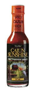 Try Me Cajun Sunshine 5 oz, bottle of hot pepper sauce with orange cap and label featuring a colorful outdoor scene with a hammock and trees.