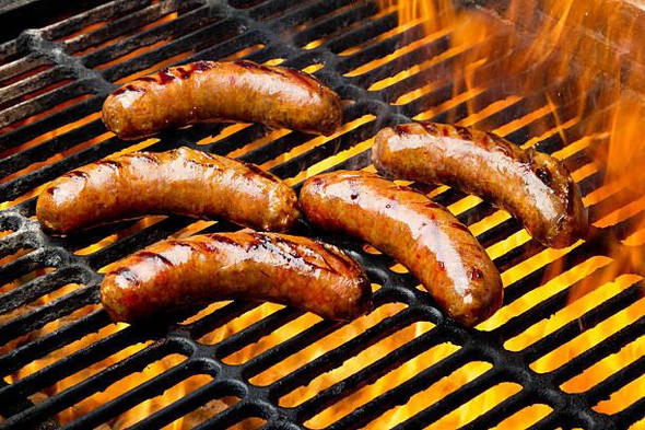 Comeaux's Smoked Pork Boudin 1lb, sizzling sausage links on grill with flames and grill marks.