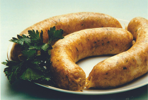 Cajun Original Pork Boudin 1lb, cooked pork sausage with herbs and spices, garnished with fresh parsley, served on a white plate.