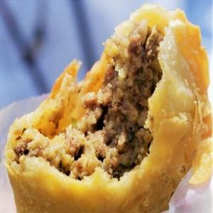 Mrs Wheat's Mild Meat Pies 48ct 4oz, close-up of a meat pie with a flaky golden crust and savory meat filling inside