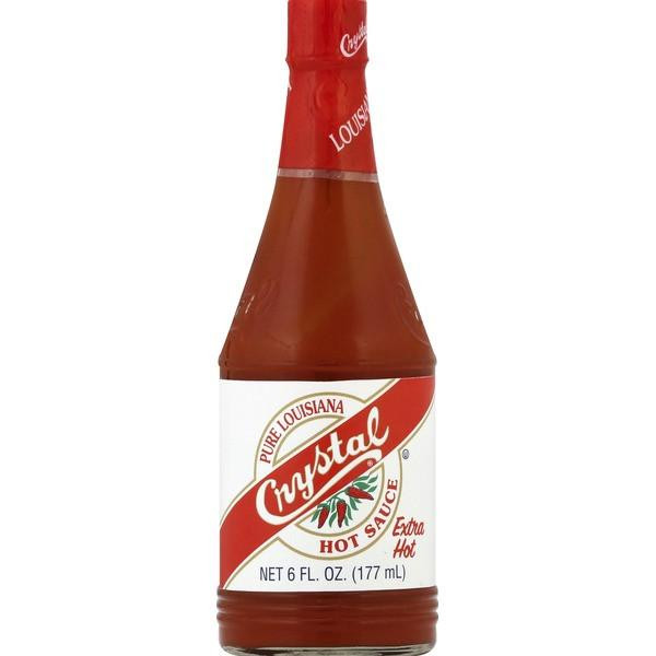 Crystal Extra Hot Sauce 6oz, glass bottle of spicy hot sauce with red cap and white label featuring red and green accents.