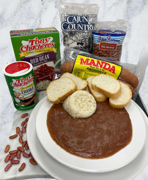 Creole Foods of Louisiana DIY Red Bean Meal Kit, assorted ingredients including beans, bread, and spices arranged on a white plate with a background of packaged seasoning mixes.
