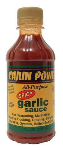 Cajun Power Spicy Garlic Sauce 8oz, a small glass bottle with a gold cap filled with spicy garlic sauce, featuring a label highlighting its flavor and versatile uses.