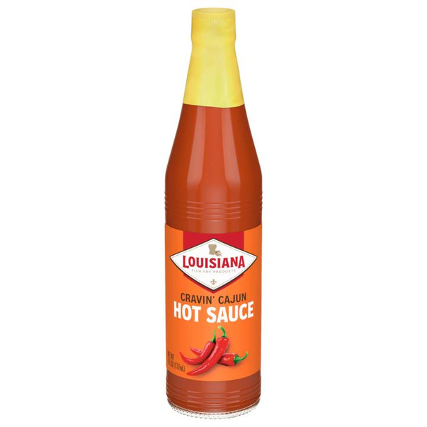 Louisiana Fish Fry Cravin Cajun Hot Sauce 6oz, a bottle of spicy hot sauce with red chili peppers on the label.
