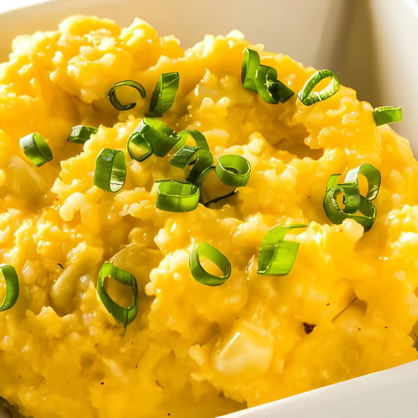 Carnival Yellow Corn Grits 4lb, close-up of cooked yellow corn grits garnished with green sliced scallions.