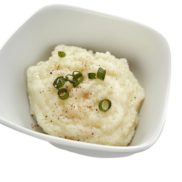 Carnival Creamy Grits with Cheese 4lb, served in a white bowl garnished with chopped green onions and black pepper.