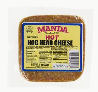 Manda Fine Meats Manda Hog Head Cheese Hot 8oz, packaged processed hog head cheese in a plastic container with yellow and purple label.