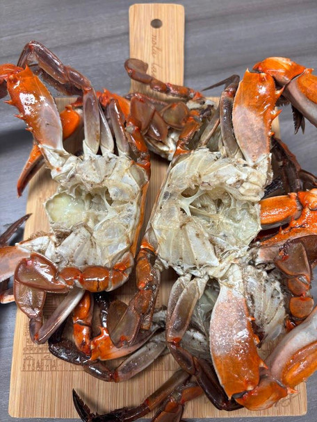 Sal's Riverside Seafood Sal's Riverside Gumbo Crabs 2lbs, fresh cooked crabs split in half on a wooden cutting board.