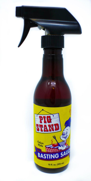 Kary's Roux Pig Stand Cajun BBQ Basting Sauce 10oz, a brown glass spray bottle with a black nozzle and a bright yellow label featuring a cartoon pig and bold text.