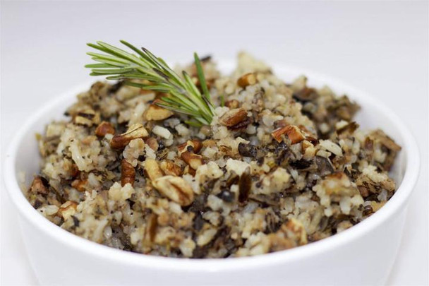La Boucherie Wild Rice Pecan Side Dish 2 lb, cooked wild rice with chopped pecans garnished with a sprig of rosemary in a white bowl.