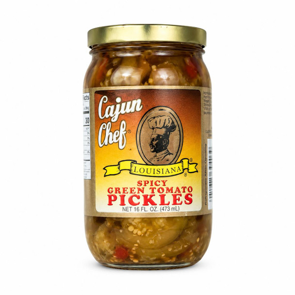 Cajun Chef Spicy Green Tomato Pickles 16oz, glass jar filled with spicy green tomato pickles featuring chunks of green tomatoes, red peppers, and spices in a clear liquid.