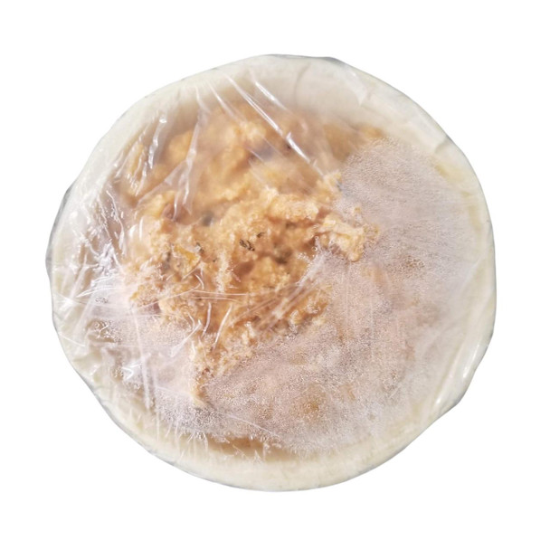 Poche's Shrimp & Crab Pie, packaged seafood pie wrapped in plastic, showing its filling of shrimp and crab meat inside a crust.