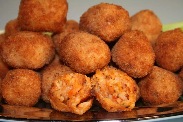 Cajun Original Alligator Boudin Balls 12lb (144 Balls), crispy fried alligator boudin balls with one cut open showing the flavorful filling inside.