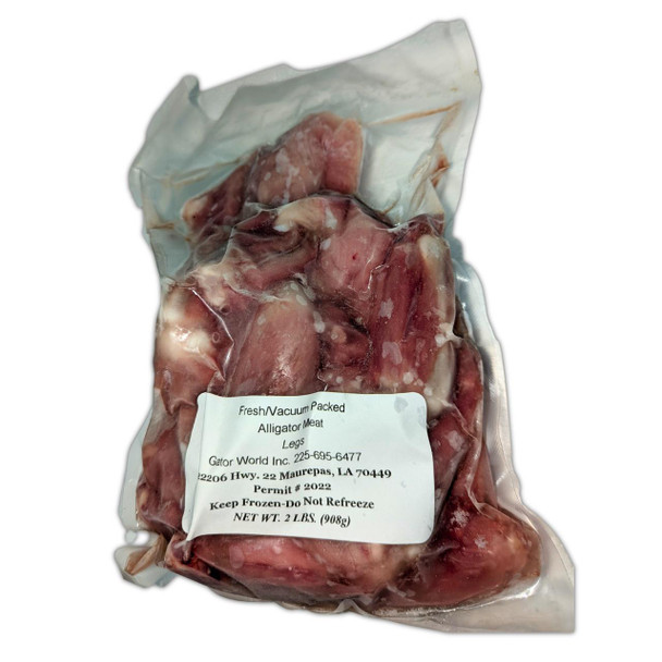 Alligator Legs Bone In 2lb, vacuum-packed alligator meat legs in clear plastic packaging with product label.