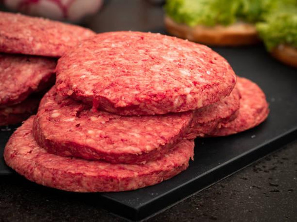 JV Foods Wagyu 5lb Ground Meat, close-up of fresh ground beef patties on a black cutting board.