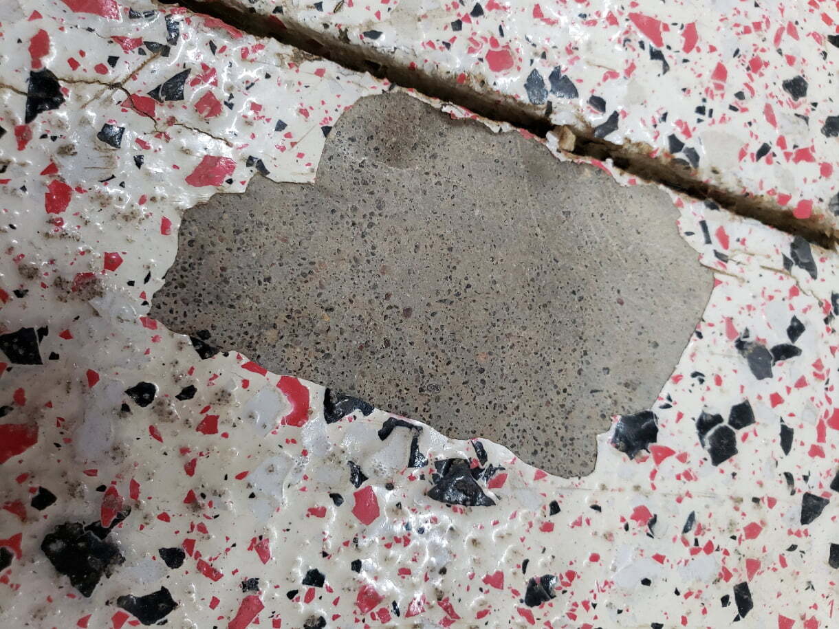 Damaged Epoxy Floor With Exposed Concrete