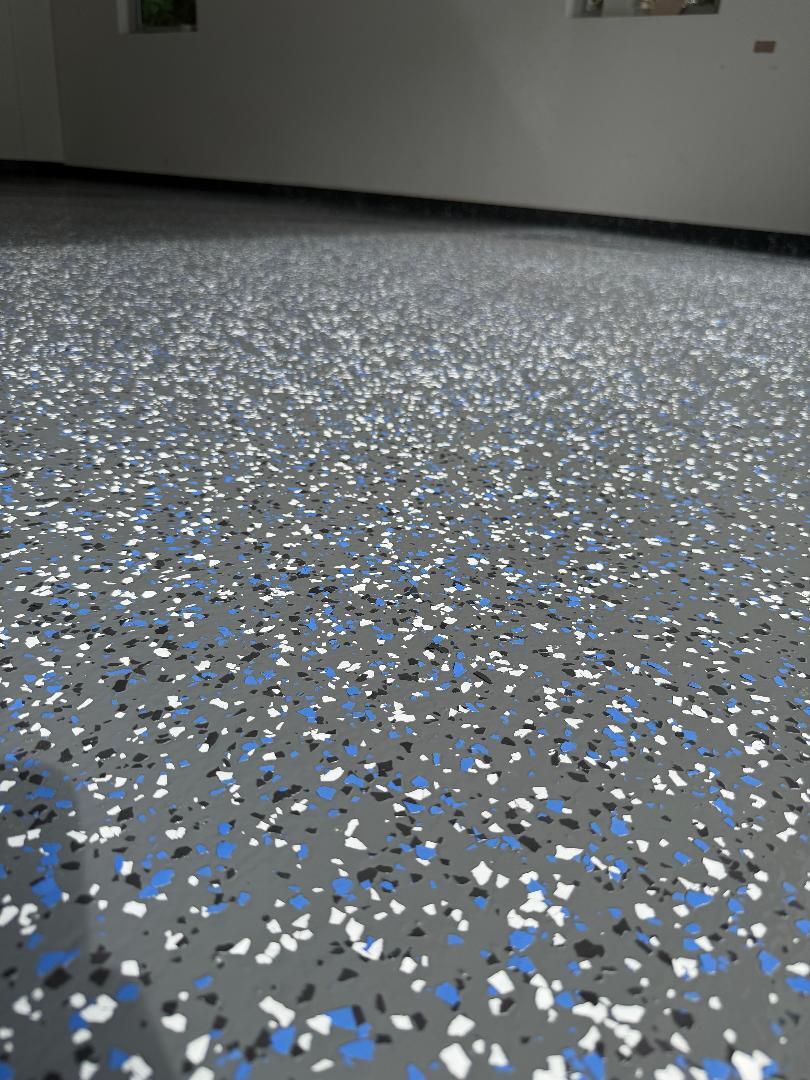 Clean Garage With A Blue Speckled Epoxy Floor