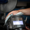 CP193 - Worker using a Vinco-TuffScrub Industrial Tool & Hand Wipe to clean a welding mask
