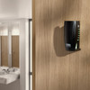 Black Rubbermaid CirculAir 90 Passive Air Care Dispenser Fitted to Wood Effect Wall with Washroom Visible to Left