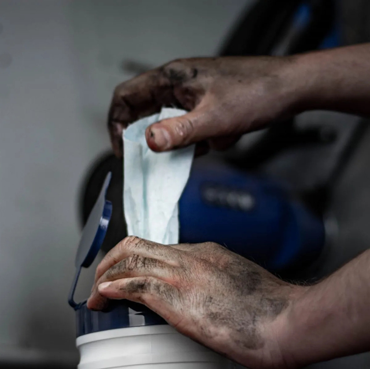 CP195 - Worker with extremely dirty hands pulls a wipe from the canister using the pop-up spout