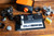 Film cameras, light meter, film rolls, and developing tools arranged on wooden table
