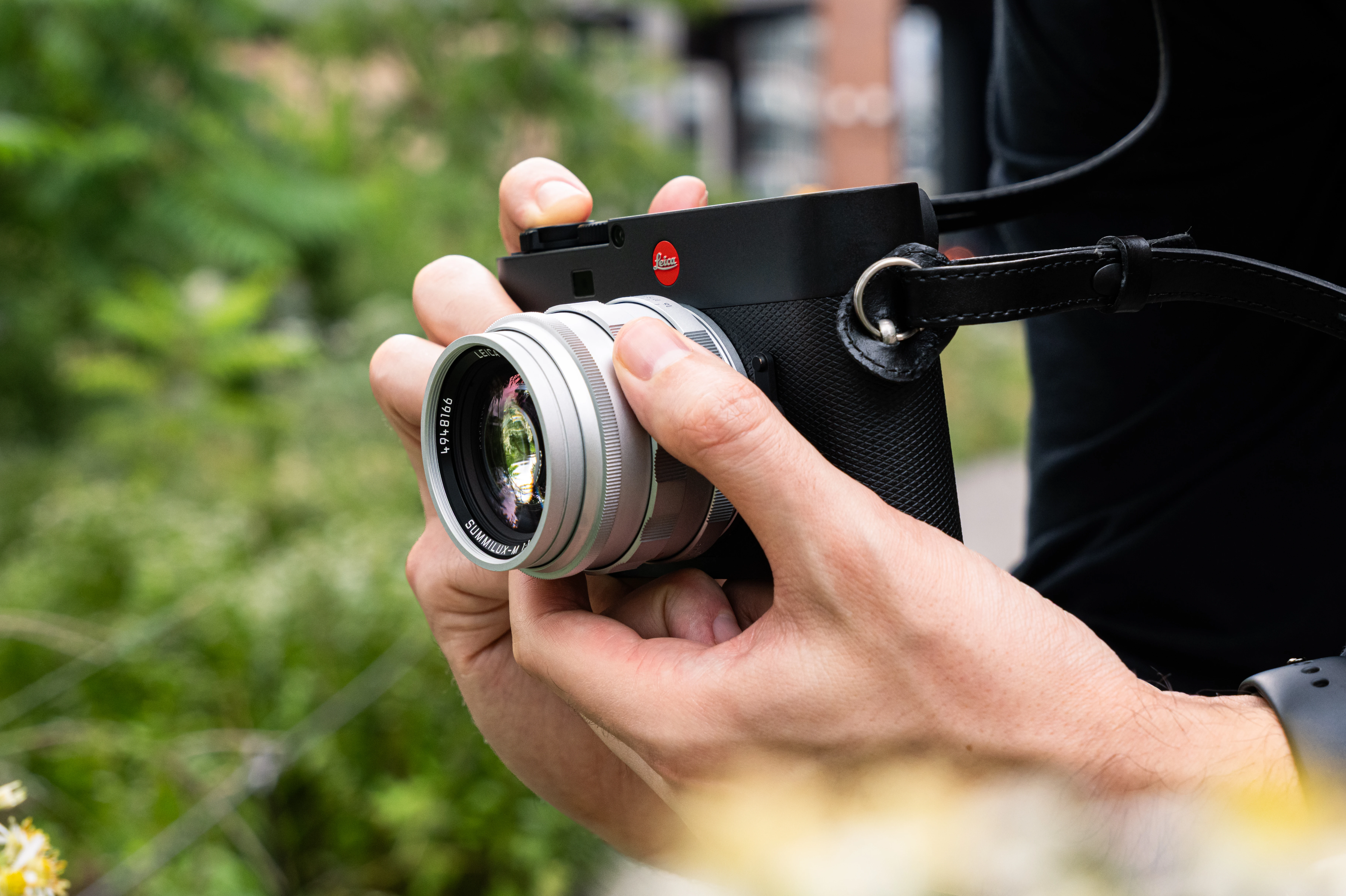 Lifestyle image of hands holding a Leica M EV1 with 50mm Summilux f/1.4