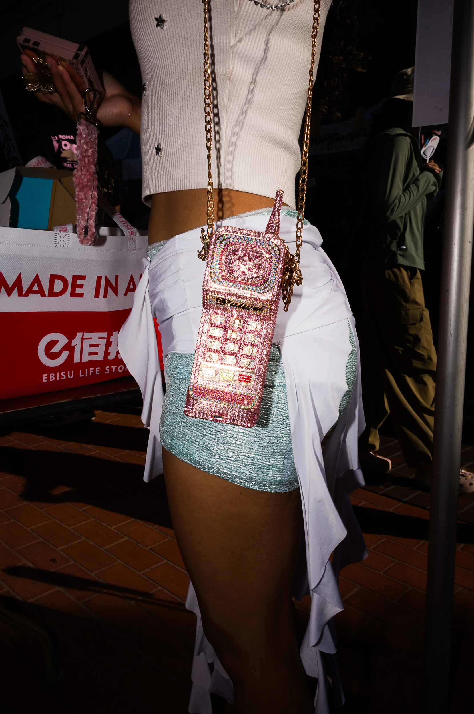 Street photograph featuring a jeweled novelty phone-shaped purse