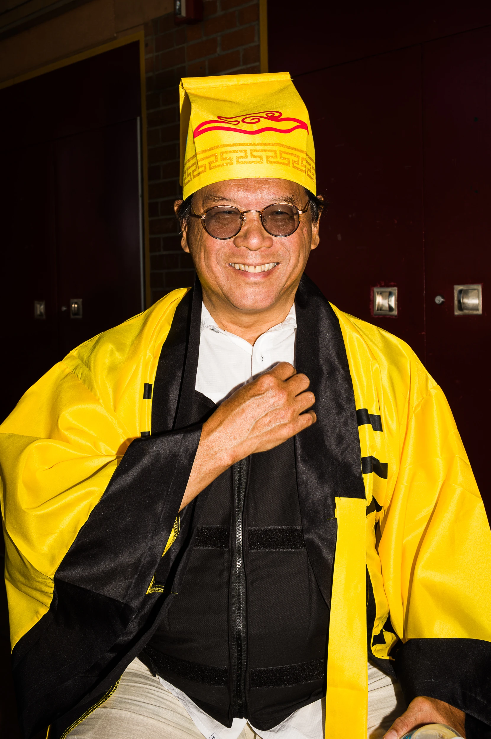 Portrait of a smiling man wearing bright yellow ceremonial clothing