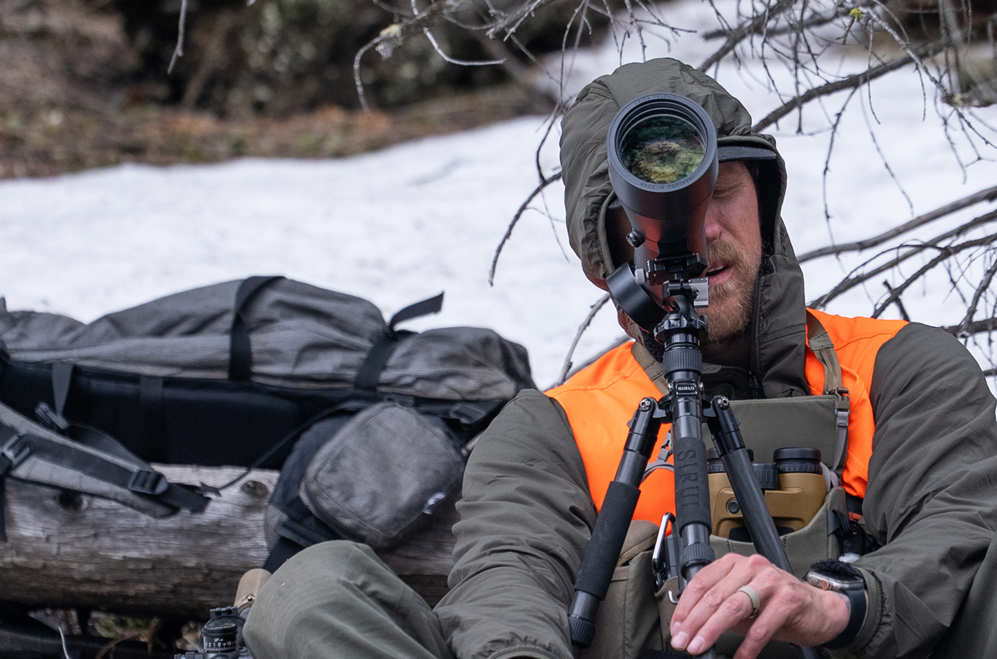 Man looking through Leica Televid Spotting Scope