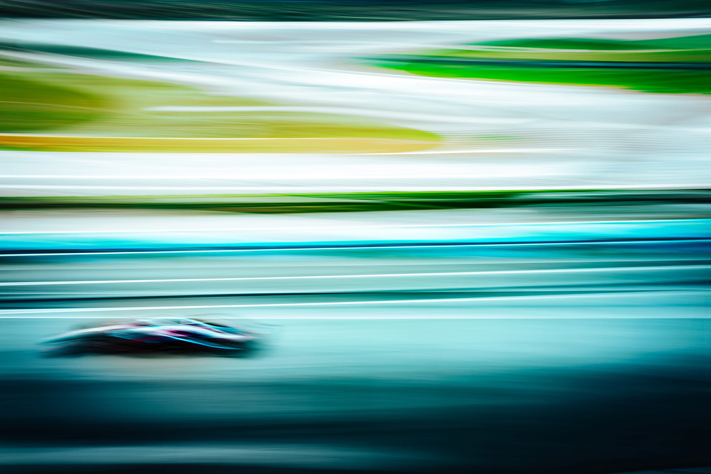 Formula 1 race car captured with motion blur while speeding along a racetrack