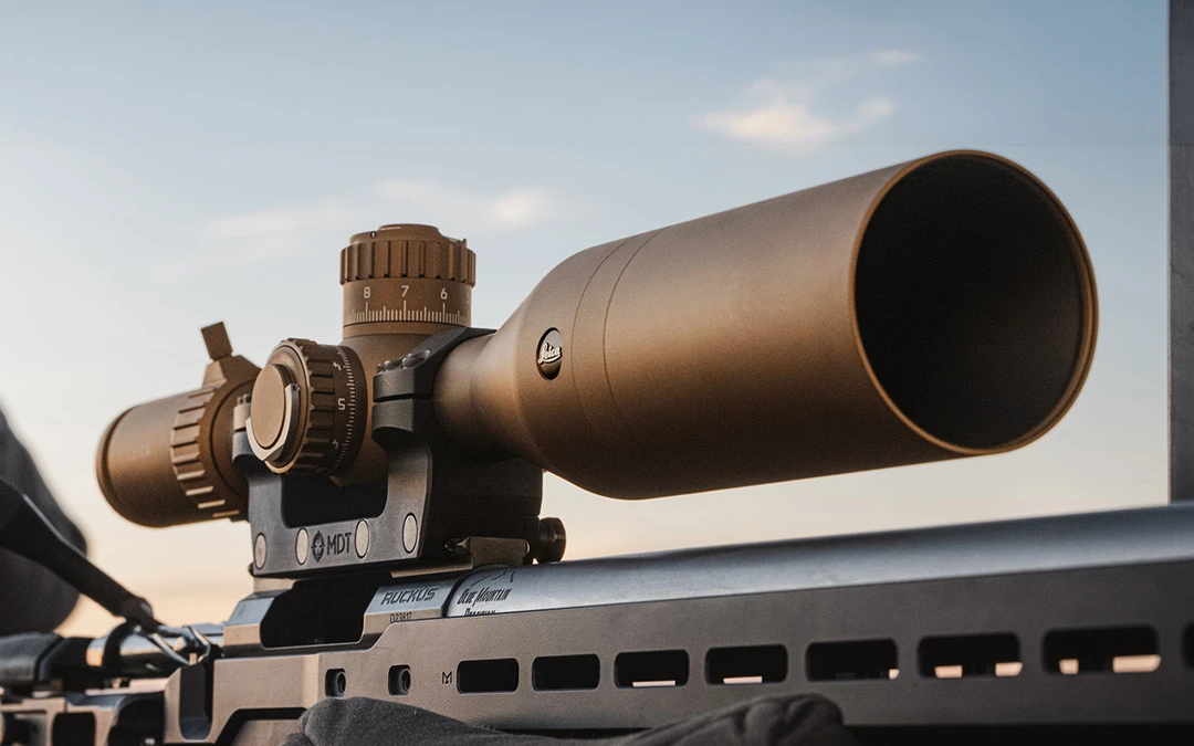 Riflescope set on top of rifle being used in field
