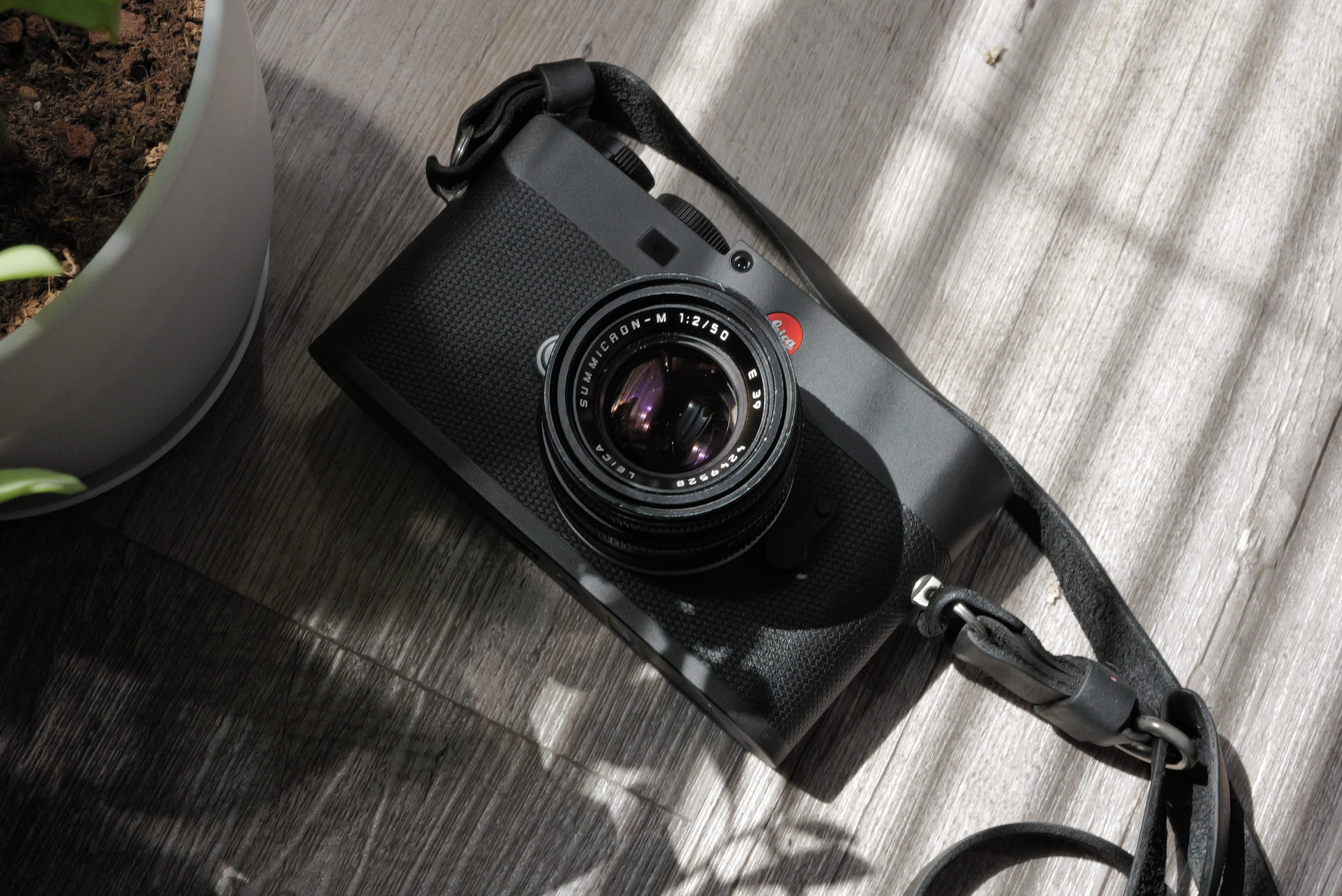 Leica M EV1 with lens resting in sunlight on a wooden floor
