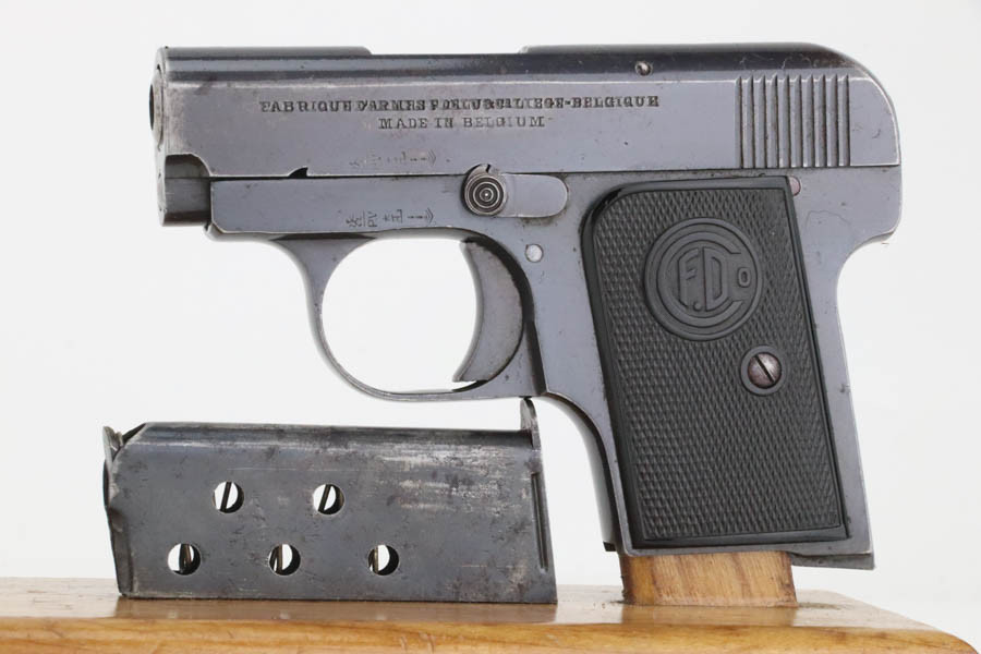F. Delu vest pocket 6.35mm pistol - left side with magazine