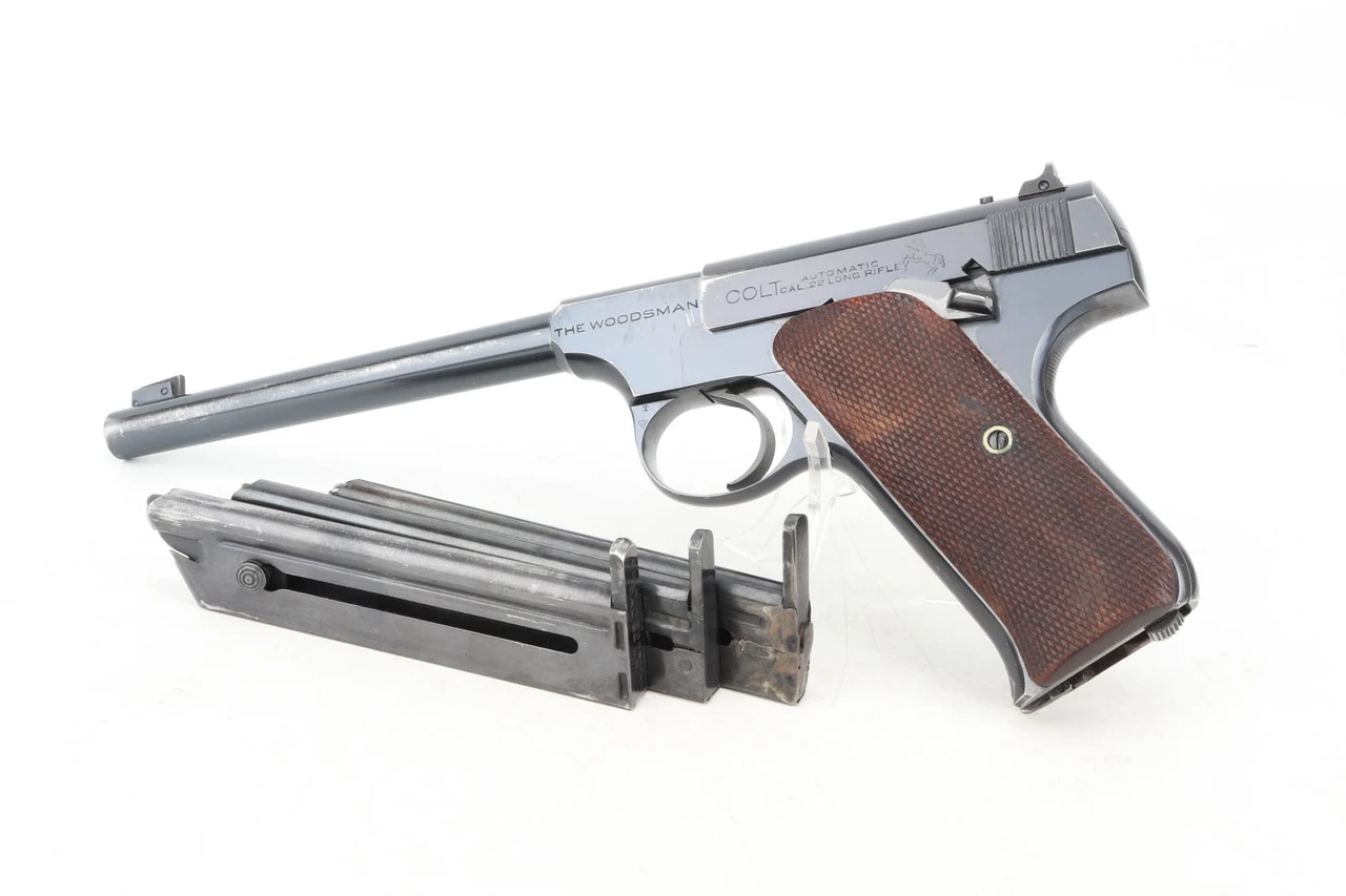 1941 Colt Woodsman .22 LR pistol left side with three magazines