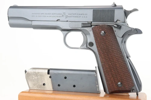 1924 transitional Colt 1911A1 in display case - left side with magazine