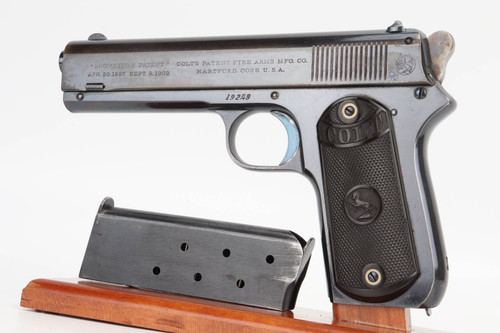 1904 Colt Model 1903 Pocket Hammer .38 - left side view with hard rubber grips and magazine