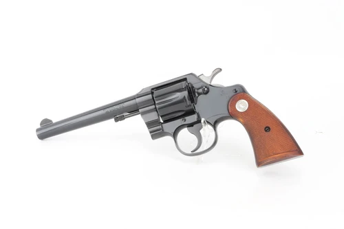 1960 Colt Official Police .38 Special revolver - left side with checkered wood grips