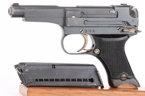 1943 out of sequence Nambu Type 94 8mm pistol - left side view with matching magazine