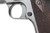 Trigger guard and checkered wood grips on Colt 1911
