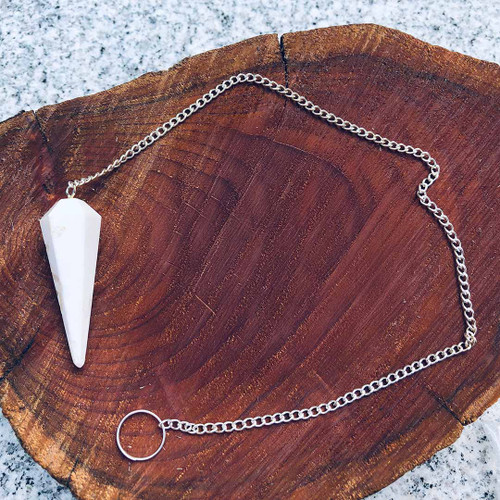 Scolecite 43mm Pendulum on timber trivet