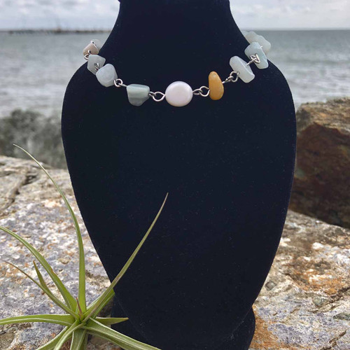 Amazonite Amethyst Crystal Chip and Freshwater Pearl Stainless Steel Anklet on black stand with air plant, rock and ocean behind