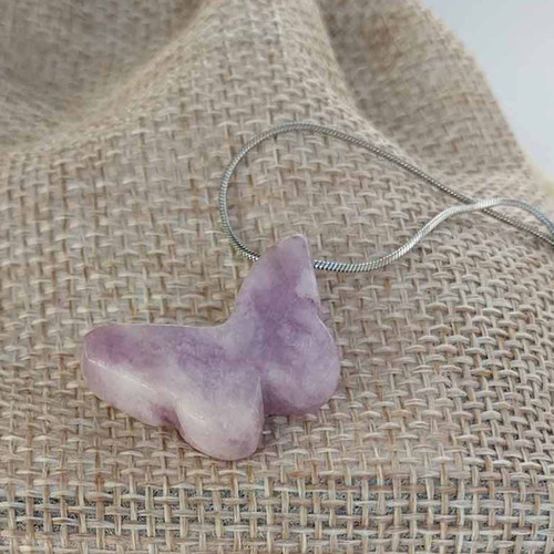Lepidolite crystal butterfly focal stainless snake chain necklace with burlap bag behind.