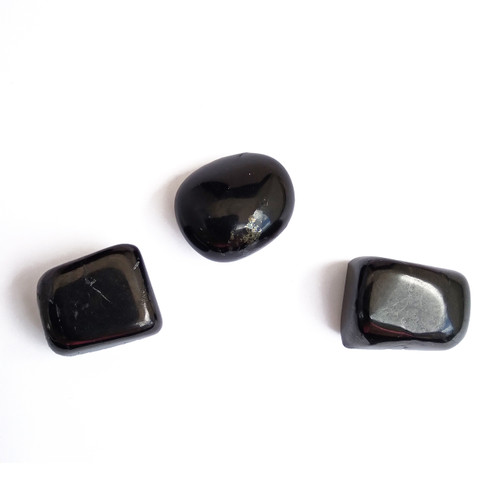 Shungite tumbled stones on a white background