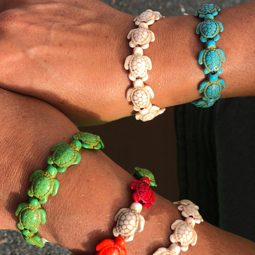 Left hand wearing Green, Mixed and Seashell, right hand wearing Seashell and Aqua coloured Turtle Charm Stretch Bracelet