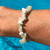 New Jade Chip bracelet on hand with water behind